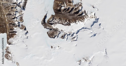 High-altitude overflight aerial of rock outcrops and bare valleys around Taylor Glacier, Antarctica. Clip loops and is reversible. Elements of this image furnished by USGS/NASA Landsat photo