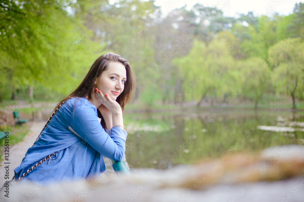 beautiful girl in a dress in the spring in a mask of dry leaf