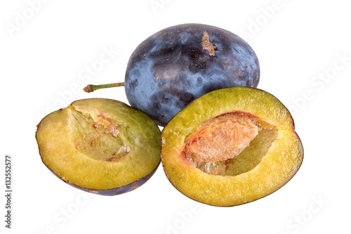 Cut plums on a white background