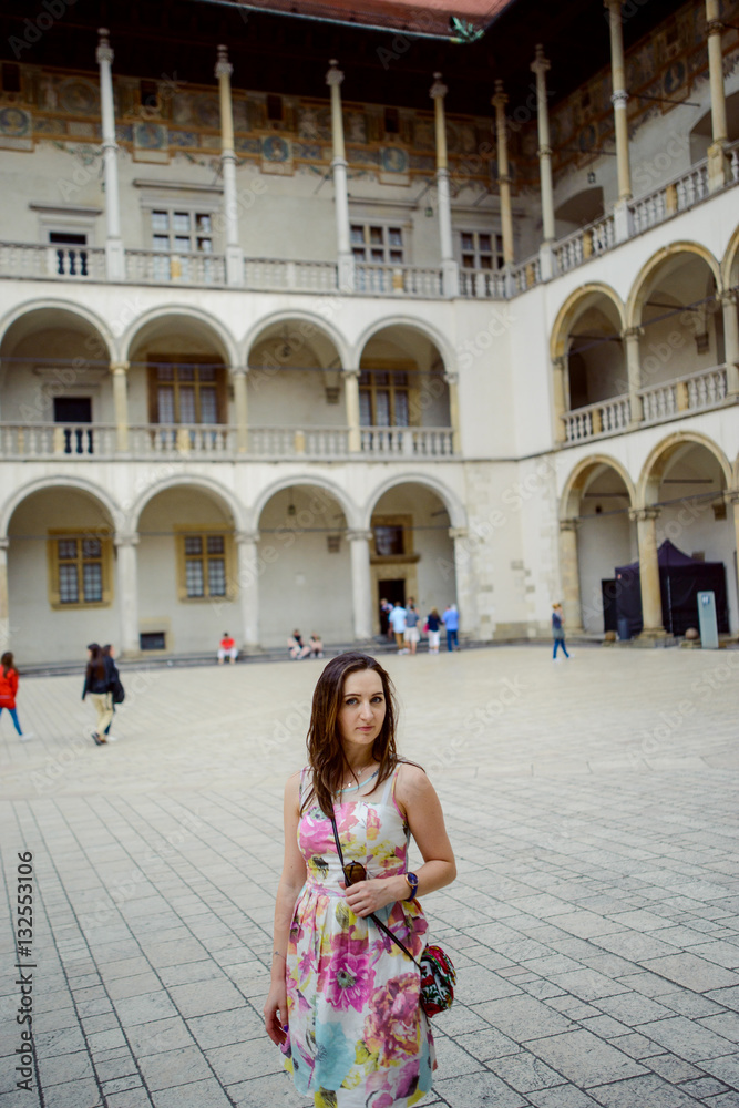 Beautiful girl during sightseeing old castle in Cracow, Wawel.