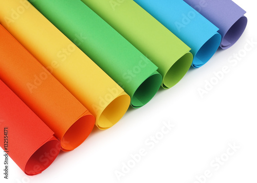 Rolls of colored construction paper isolated with shadows on white background.