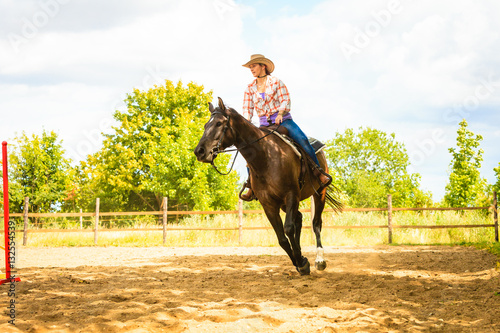 Cowgirl doing horse riding on countryside meadow © Voyagerix