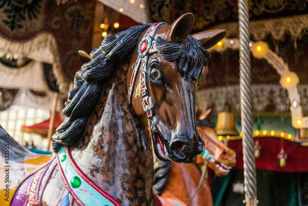 Carousel at a carnival or festival. Decorative ornate horse at a fun fair.