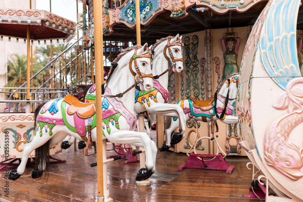 Carousel at a carnival or festival. Decorative ornate horse at a fun fair.