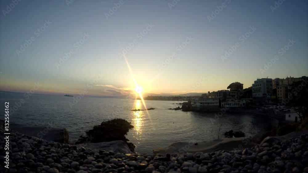 Beautiful sunset on the seafront with villas and old houses. Wild beach with rocks and rocky terrain. Soft sunset in the Gulf. Italy Genoa. Beautiful sunset on the seafront with villas and old houses. Wild beach with rocks and rocky terrain. Soft sunset in the Gulf. Italy Genoa.
