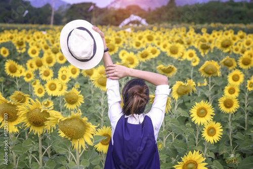beautiful girl enoy in field of sunflowers photo