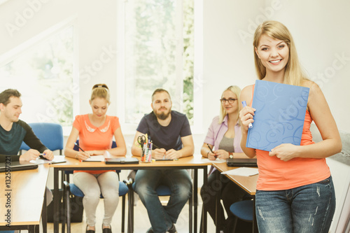 Student girl in front of her mates in classroom © Voyagerix