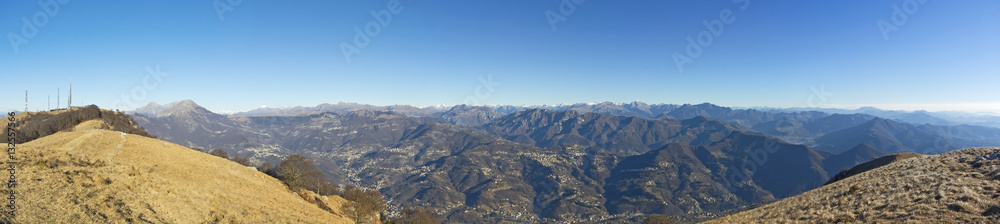 Great landscape with fantastic blue sky on the Orobie Alps and Padana plain a dry winter season without snow. Panorama from Linzone Mountain, Bergamo, Italy. 