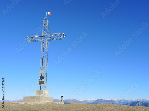 The cross on top of Mount Linzone in a fantastic blue sky day. Orobie Alps, Bergamo, Italy. 