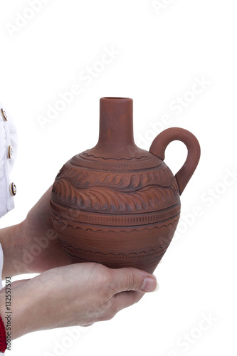 Clay pitcher in female hands