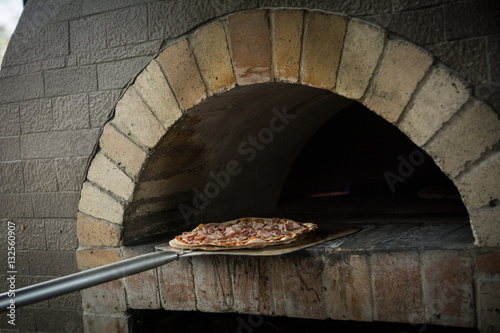 Hands preparing a pizza  (dark background)