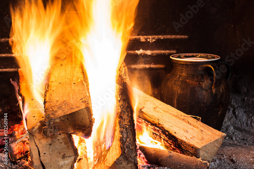 cook with pot near the fire