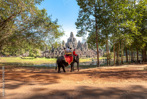Tourists on an ride elephant tour of Bayon temple in Angkor Thom,landmark in Siem Reap, Cambodia.