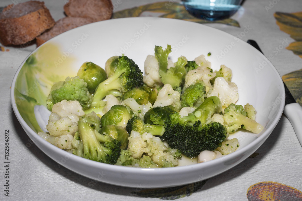 A plate of freshly cooked broccoli and cauliflower A plate of freshly cooked broccoli and cauliflower