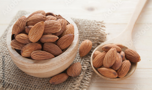 group of almonds  from wood bowl