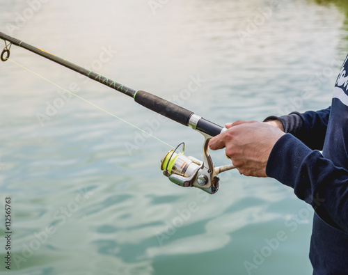 Human handle fish hook in natural environmet photo