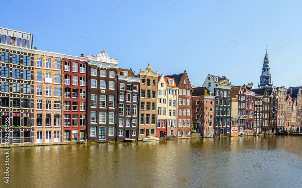 Colorful canal houses on the Damrak in the Dutch capital Amsterd