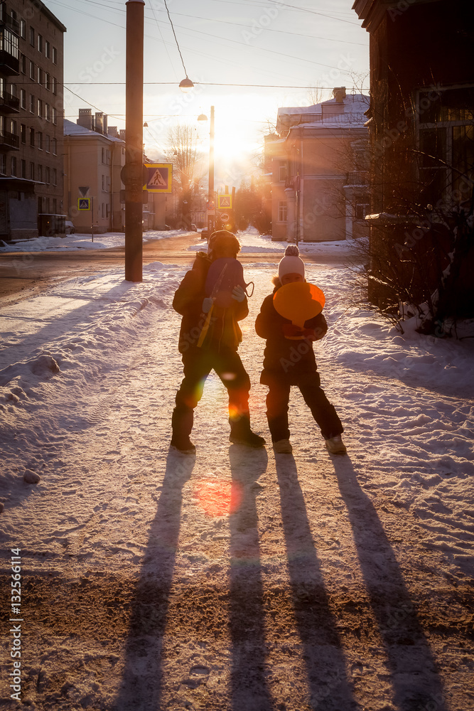 Children are on the street in the city in winter