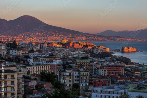 Aerial view of Naples with castle and Vesuvius mount at the suns