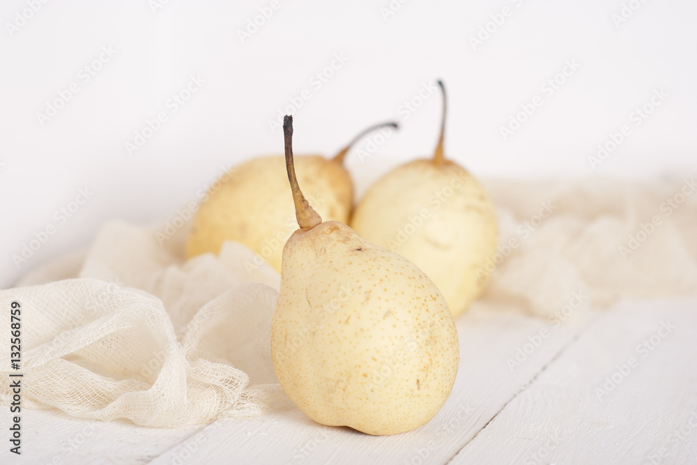 chinese pears on white wooden table chinese pears on white wooden table