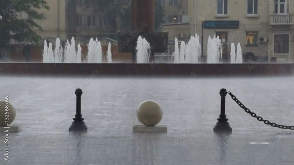 Heavy rain at the city railway station square. Sea port of Novorossiysk.
