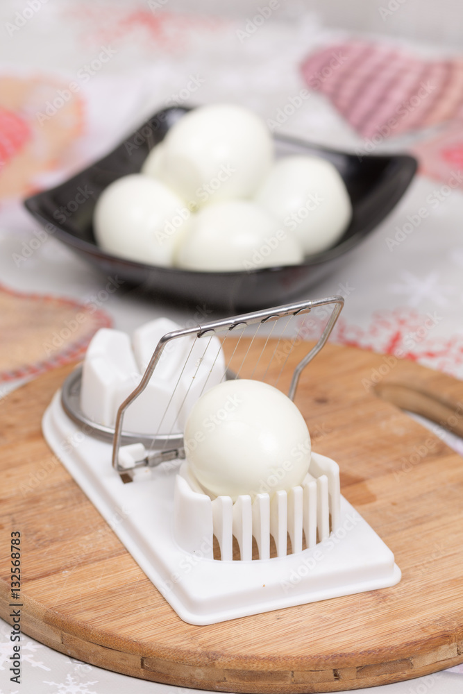 Boiled and pealed eggs served on the black plate Boiled and pealed eggs served on the black plate