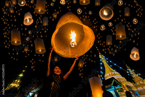 Beautiful asian women release sky lanterns to worship buddha's 