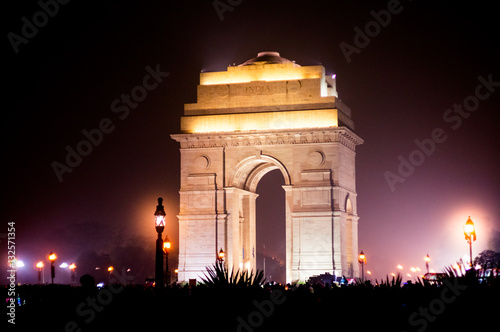 India gate at night with multicolored lights. This landmark is one of the main attractions of Delhi and a popular tourist destination. It was designed by Edwin Luytens