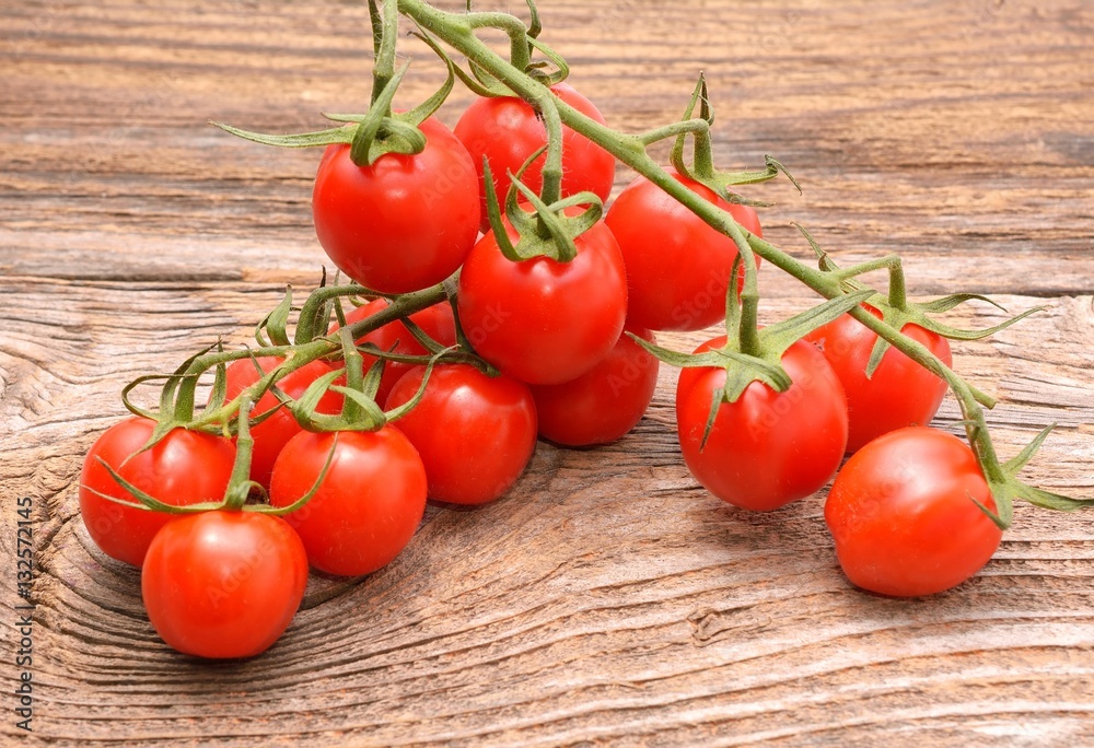 Fresh cherry tomatoes on rustic wooden background Fresh cherry tomatoes on rustic wooden background