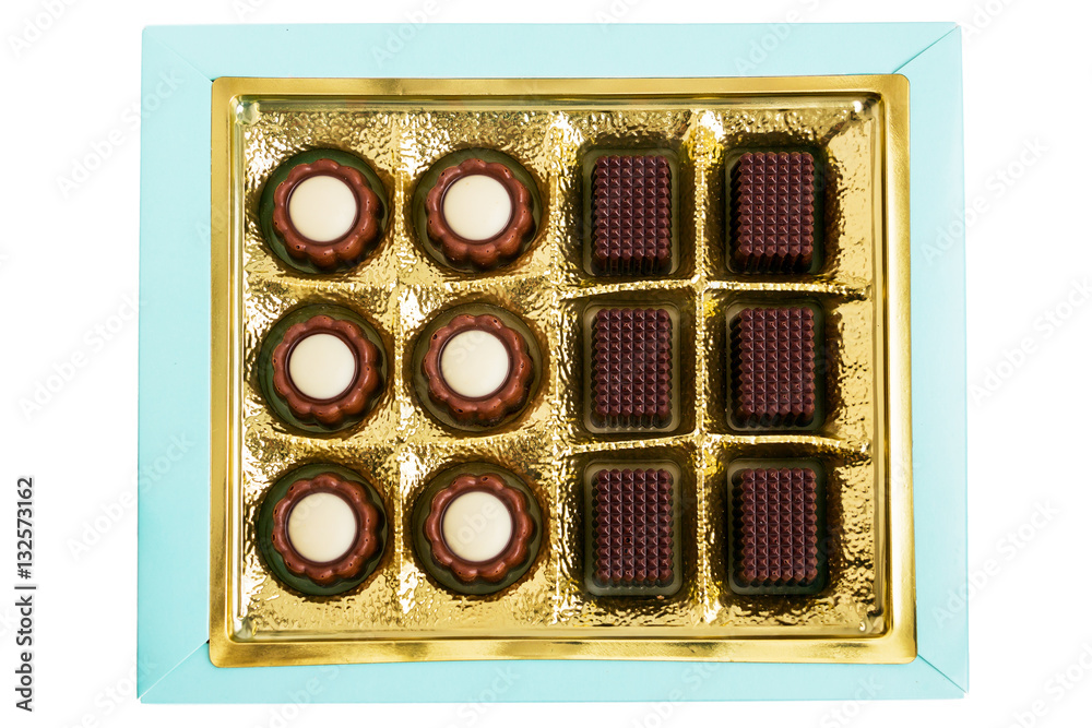 Chocolates in gold are in the box isolated on white background Chocolates in gold are in the box isolated on white background