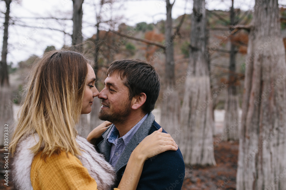 happy couple outdoor. hugging and kissing man and woman in park