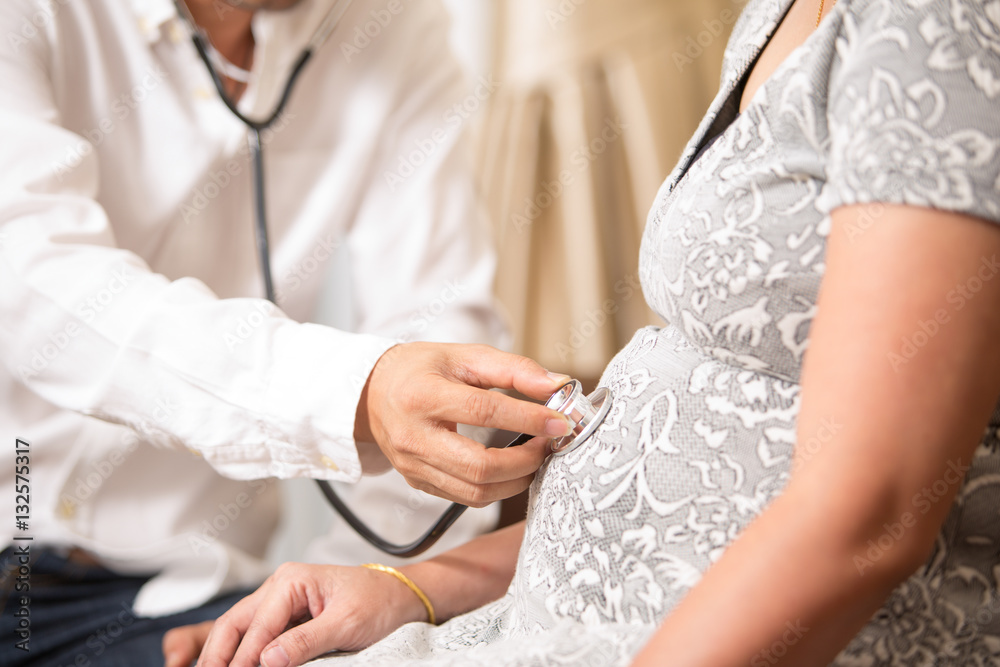 Doctor examining pregnant woman.
Doctor examining pregnant woman.