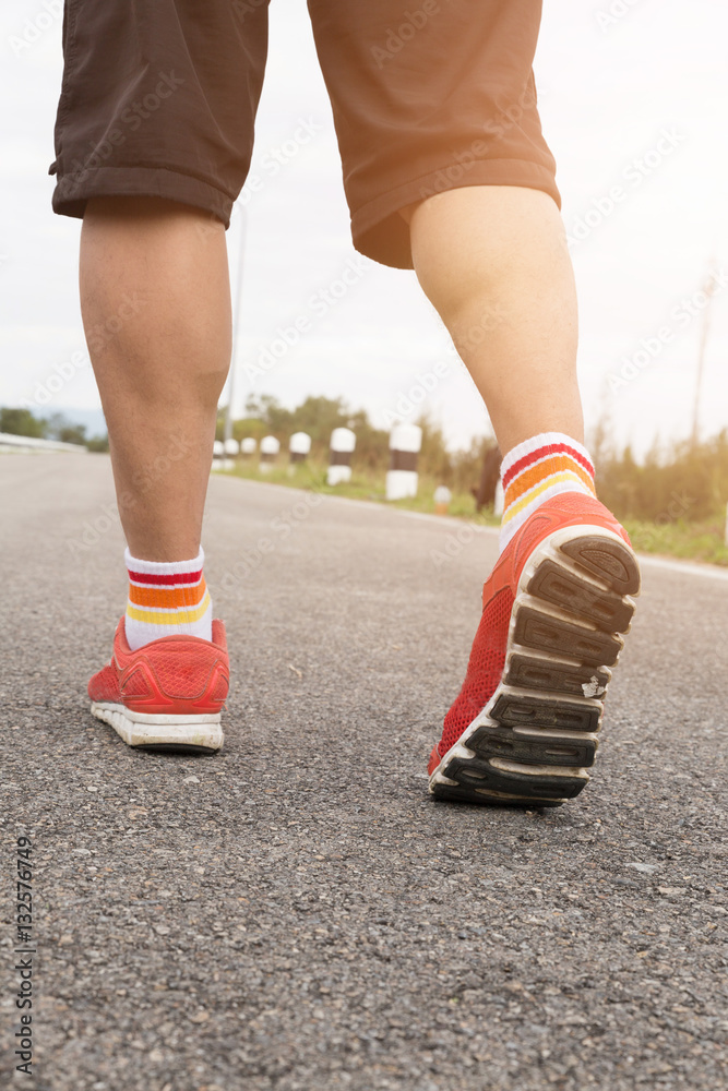 athletic young man running on road in the park. Healthy lifestyl athletic young man running on road in the park. Healthy lifestyl