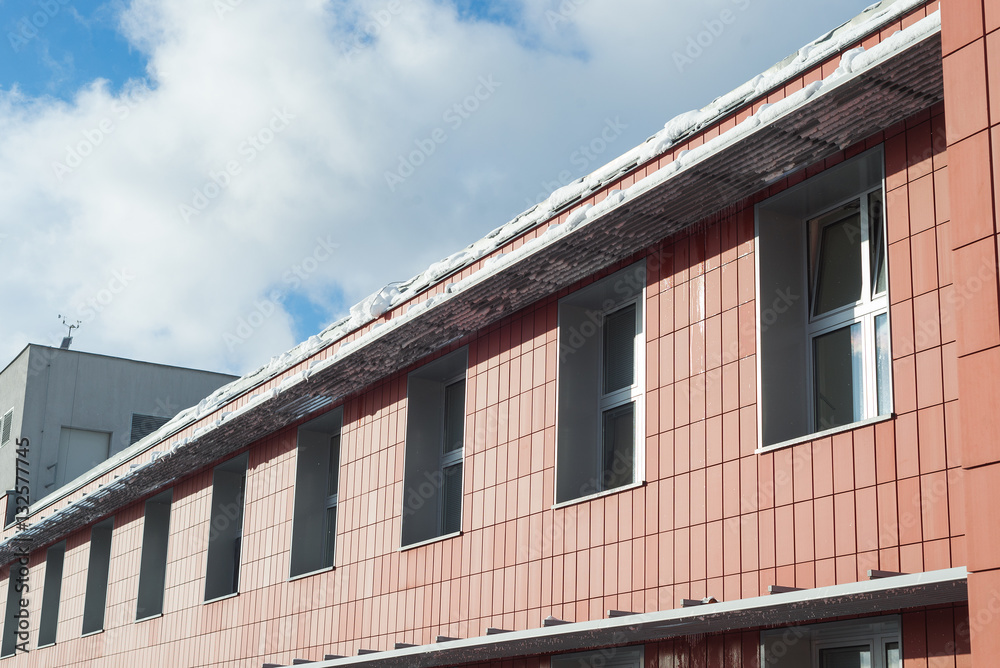 Snow on a roof - riskof falling and sliding down, caution Snow on a roof - riskof falling and sliding down, caution