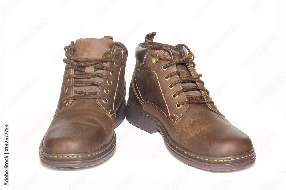 Brown man's leather boots isolated on white background.