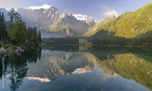 misty morning on the alpine lake laghi di Fusine, Italy