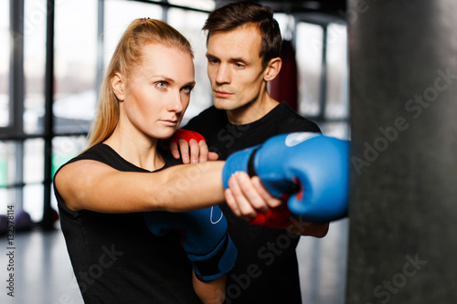 Boxing coach trains young woman © snedorez