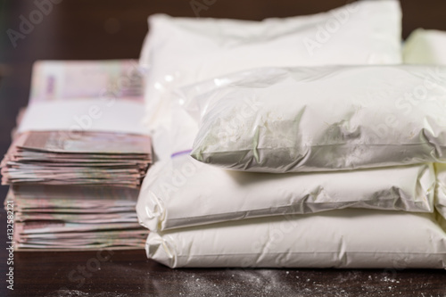 Bags of drugs, and money on table