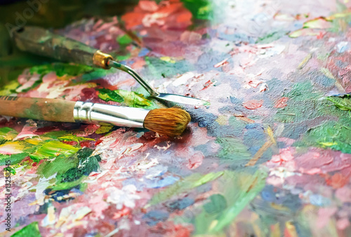 artist's palette with oil paints and brushes