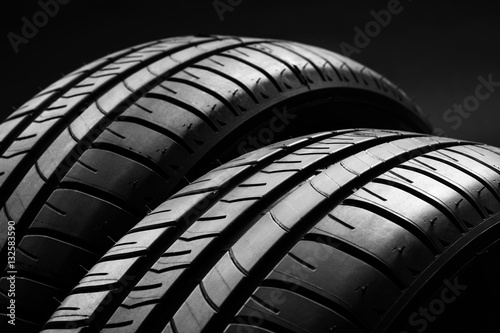 Studio shot of a set of summer, fuel efficient car tires on black background. Contrasty lighting and shallow depth of field