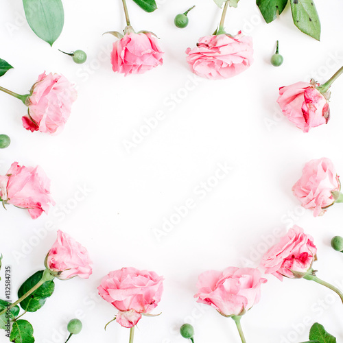 Frame made of pink roses on white background. Flat lay, top view. Valentine's background