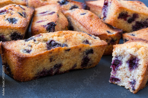 Homemade french financier cookies with bilberry on a grey backgr