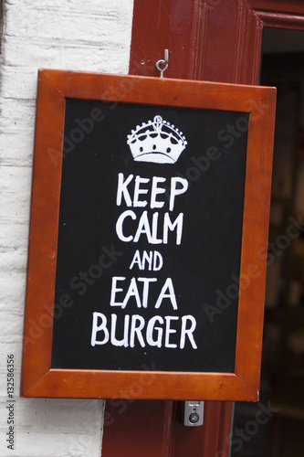 Advertising text on a blackboard : Keep calm eat a burger