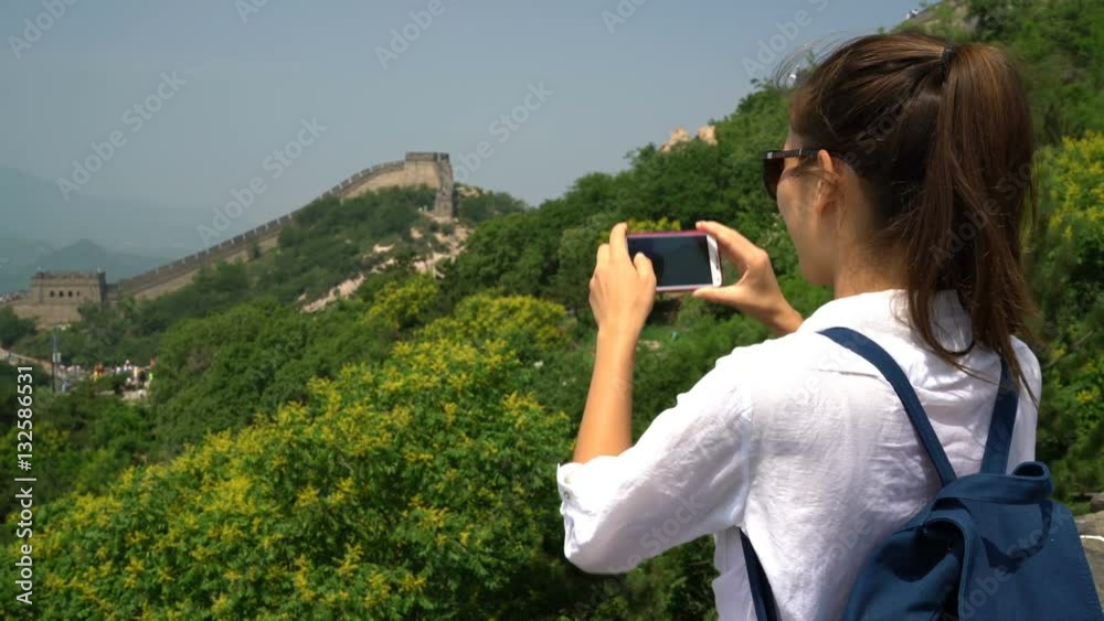 Great Wall of China. Tourist taking photo at famous Badaling during travel vacation holidays sightseeing Chinese tourist attractions. Woman tourist taking picture using smart phone in Asia. Great Wall of China. Tourist taking photo at famous Badaling during travel vacation holidays sightseeing Chinese tourist attractions. Woman tourist taking picture using smart phone in Asia.