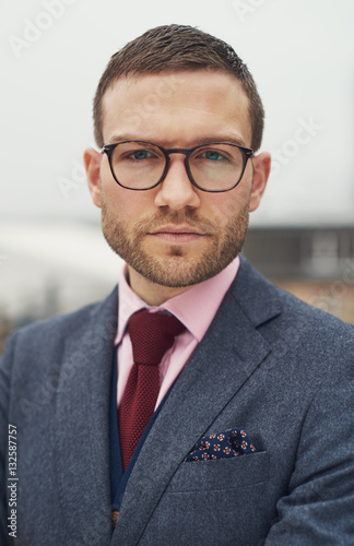 Stern stylish young businessman