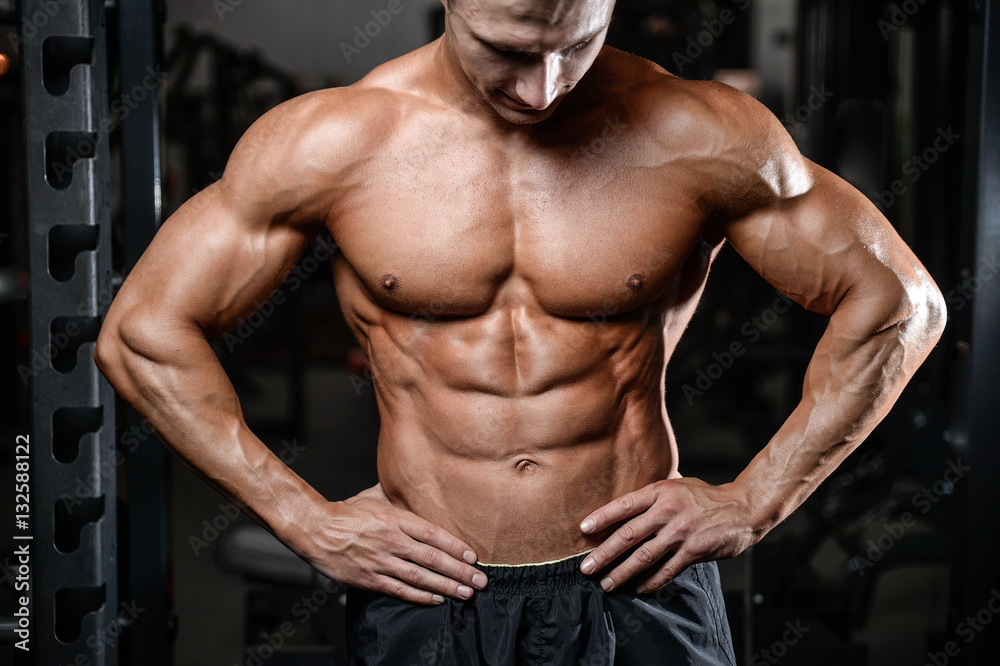 Fototapeta premium Handsome fitness model train in the gym gain muscle