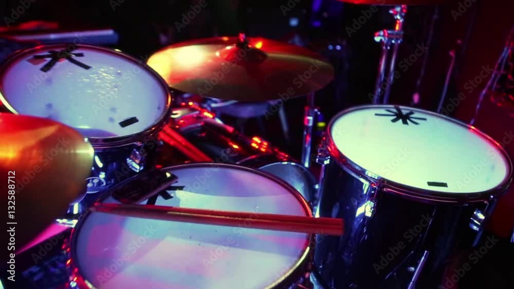 Drum set with lights. Concert rock band performing on stage with singer performer, guitar, drummer. Music video punk, heavy metal or rock group. Drum set with lights. Concert rock band performing on stage with singer performer, guitar, drummer. Music video punk, heavy metal or rock group.
