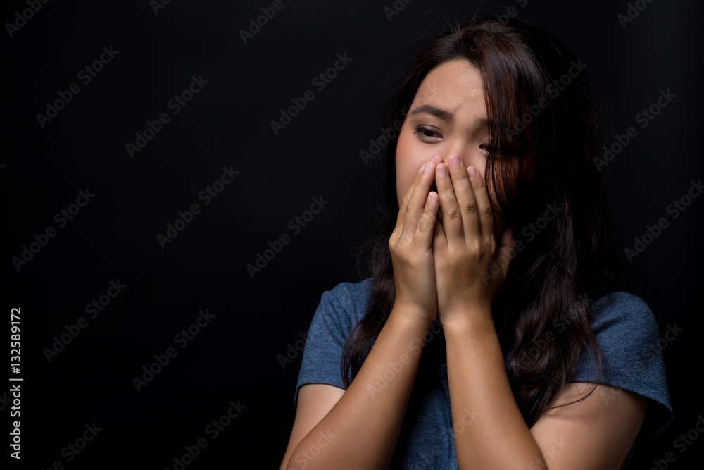 Sad woman on isolated black background Sad woman on isolated black background