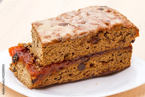 Fruit-Cake with raisins on a white plate