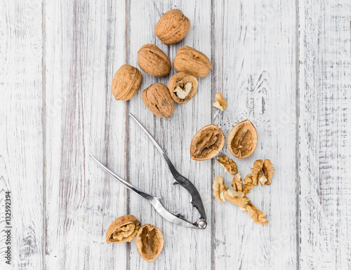 Portion of Whole Walnuts on wooden background (selective focus)